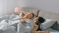 In the Morning Sun Rises and Wakes Up Cute Young Couple in Bed, They Look at Each Other Tenderly a Royalty Free Stock Photo