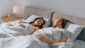 In the Morning Sun Rises and Wakes Up Cute Young Couple in Bed, They Look at Each Other Tenderly a Royalty Free Stock Photo