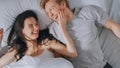 In the Morning Sun Rises and Wakes Up Cute Young Couple in Bed, They Look at Each Other Tenderly a Royalty Free Stock Photo