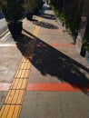 Morning sunlight on a pedestrian sidewalk Royalty Free Stock Photo