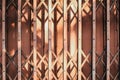 Morning sunlight and shadow on the closed metal steel door - Folding door texture pattern and background.