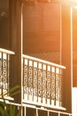 Morning sunlight on surface of wooden balustrade on terrace of vintage house