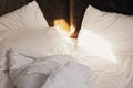 Morning sunlight touching messy unmade bed Royalty Free Stock Photo