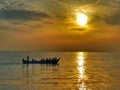 Morning sunrise boating sailing fishing fishermen beach sea ocean Royalty Free Stock Photo