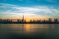 Morning or sunrise in Dubai. Dawn over Burj Khalifa. Beautiful colored cloudy sky over downtown Dubai. Solar path on sea Royalty Free Stock Photo