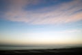 Morning sunrise over body of water with cloudy sky Royalty Free Stock Photo