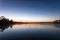 Morning sunrise over the lake with silhouette tree reflect on water surface Royalty Free Stock Photo