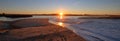 Morning sunrise reflections over tide outflow of the Santa Clara river at McGrath State Park on California`s Gold Coast USA Royalty Free Stock Photo