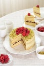 Morning table with beautiful pistachio sponge cake and pistachio cream with fruit