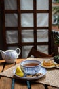 Morning tea time, cup of natural tea, teapot, organic honey, fresh green tea leaves and organic fruits