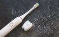 Morning teeth and face care. electric ultrasonic toothbrush and floss on black background. top view flat lay Royalty Free Stock Photo