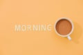 MORNING text with a cup of coffee with shadow on pink background Royalty Free Stock Photo