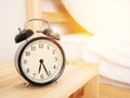 Morning time background, retro alarm clock near the bed at home Royalty Free Stock Photo