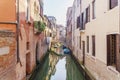 Morning Venice in sunrise lights with boats and bright buildings.