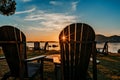 Morning vibes. Beautiful calm sunrise at seaside with sun rays shining through beach wooden chair Royalty Free Stock Photo