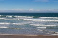 Morning view of the beach with breaking waves crashing sand on s