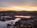 Morning view of a beautiful frozen puddles and mosses on the rocky slope of the mountain close up. Picturesque Arctic landscape in