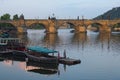 Morning view on the Charles Bridge across the Vltava River. Boat harbor in the front. Prague, Czech Republic Royalty Free Stock Photo