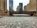 Morning view of frozen Chicago River and surrounding cityscape during heavy snowfall. Royalty Free Stock Photo