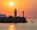Morning view of the lighthouse against the backdrop of the sun continuing to rise towards its zenith Royalty Free Stock Photo