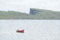 Morning view on lonely boat on cloudy Sorvagsvatn lake