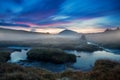 Morning view on the mountain landscape with the dominant hill and large meadow and brook.