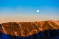 Morning View of Mountain Ridge with Full Moon on Blue Sky Royalty Free Stock Photo