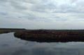 Morning view. Nature landscape. An island alongside the river with dark blue water