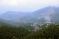 Morning view of residental area and houses around the Dragobrat mountain peaks in Carpathian mountains, Ukraine. Cloudy Royalty Free Stock Photo
