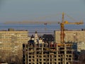 Morning view of a residential house under construction and the Volga Region Orthodox Institute in the background. Royalty Free Stock Photo