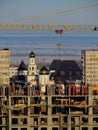 Morning view of a residential house under construction and the Volga Region Orthodox Institute in the background. Royalty Free Stock Photo