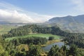 Morning view of Telaga Warna Lake with mountain background at Dieng Plateau, Central Java, Indonesia. Aerial View from Batu Royalty Free Stock Photo