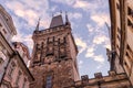 A morning view of the top of a medieval stone tower with statues on an ancient bridge in Prague, Czech Republic. Royalty Free Stock Photo