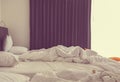 Rumpled unmade bed of white bedroom interior Royalty Free Stock Photo