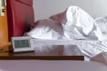 morning wake up with alarm clock and white bedding sheets and p Royalty Free Stock Photo