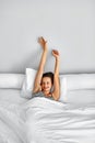 Morning Wake Up. Woman Waking Stretching In Bed. Healthy Lifestyle Royalty Free Stock Photo