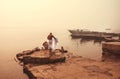 Morning washing in misty indian river Ganga, Varanasi. Calm meditative atmosphere with local people in India