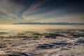 Morning wide angle view of entire Tatra range above glowing fog Royalty Free Stock Photo