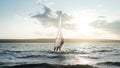 Morning windsurfing on the lake sunrise