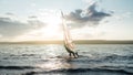 Morning windsurfing on the lake sunrise