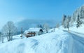Morning winter misty rural alpine road and house Royalty Free Stock Photo