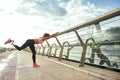 Morning workout. Disabled athletic woman with prosthetic leg in sportswear doing sport exercises while standing on the Royalty Free Stock Photo