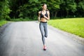 Morning of young fitness woman running outdoors in the park Royalty Free Stock Photo