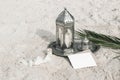 Moroccan, Arabic lantern with cup of tea, coffee and date palm leaf on silver tray in sand. Muslim holiday Ramadan