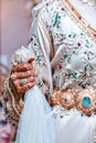 A Moroccan bride close-up wearing a traditional Moroccan caftan with henna on her hands