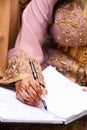 A Moroccan bride signs his wedding book.