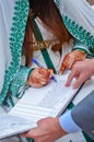 A Moroccan bride signs his wedding book.