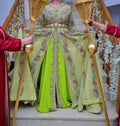 A Moroccan bride wears a green caftan.