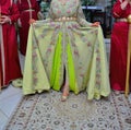 A Moroccan bride wears a green caftan.