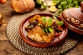 Moroccan Chicken and Vegetables Tangine with bread served in a dish isolated on wooden background side view Royalty Free Stock Photo